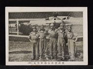 Five men stand in front of a propeller plane